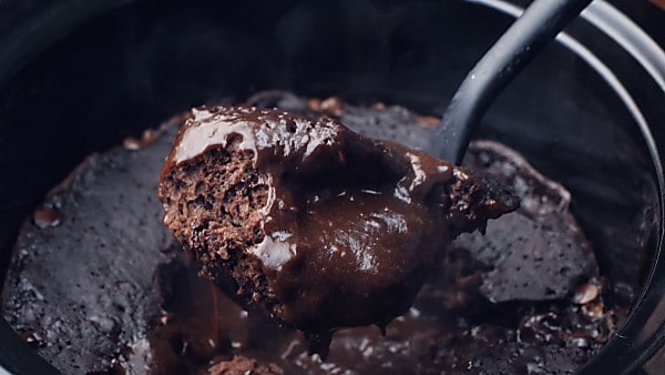 finished lava cake being scooped with ladle