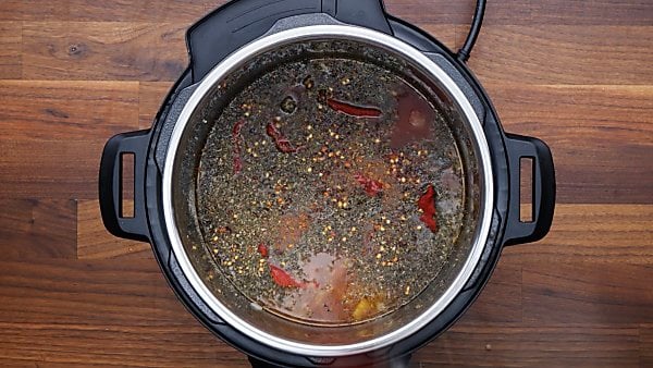 tomatoes, tomato sauce, seasonings, and tomato paste added into instant pot