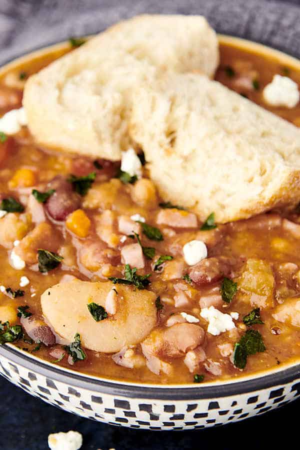 15 bean soup in a bowl with slices of bread