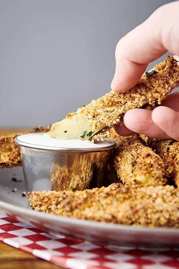 air fried pickle dipping into ranch