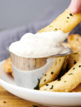 french fry dipping into aioli
