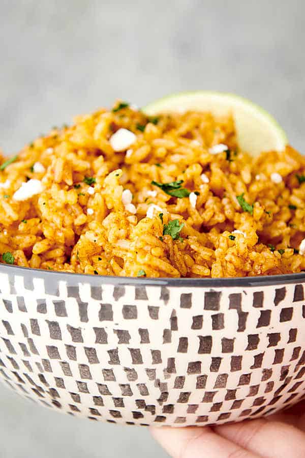 holding a bowl of spanish rice