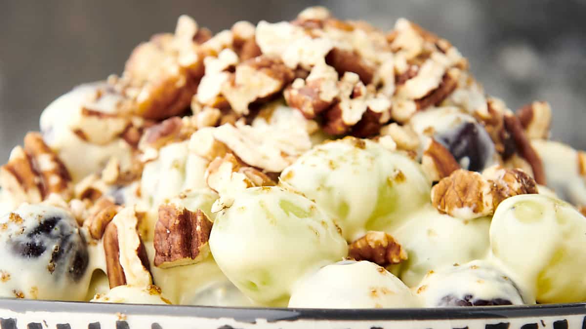 grape salad in a bowl with pecan brown sugar topping
