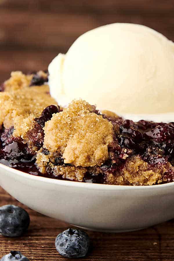 blueberry cobbler in a bowl with ice cream