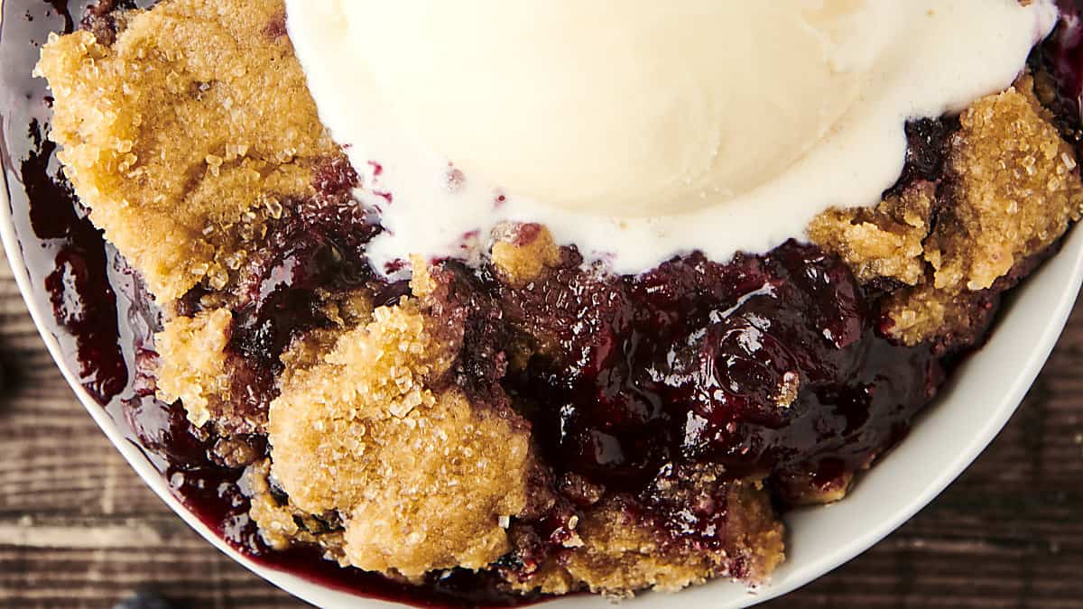 easy blueberry cobbler in a bowl with vanilla ice cream