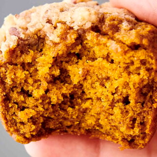 holding a pumpkin muffin with pecan streusel