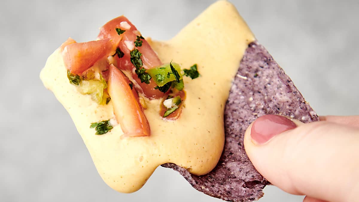 vegan cashew queso on a chip with pico de gallo