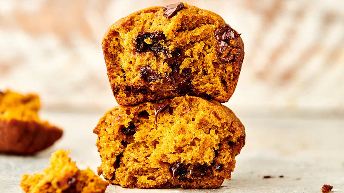 easy pumpkin chocolate chip muffins stacked on top of each other