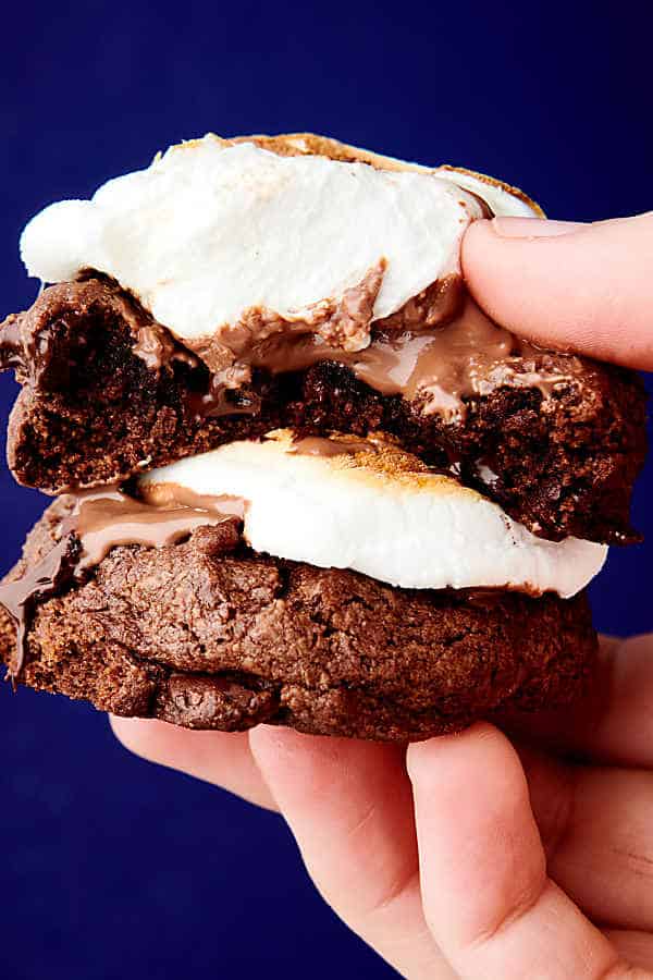 holding two hot chocolate cookies