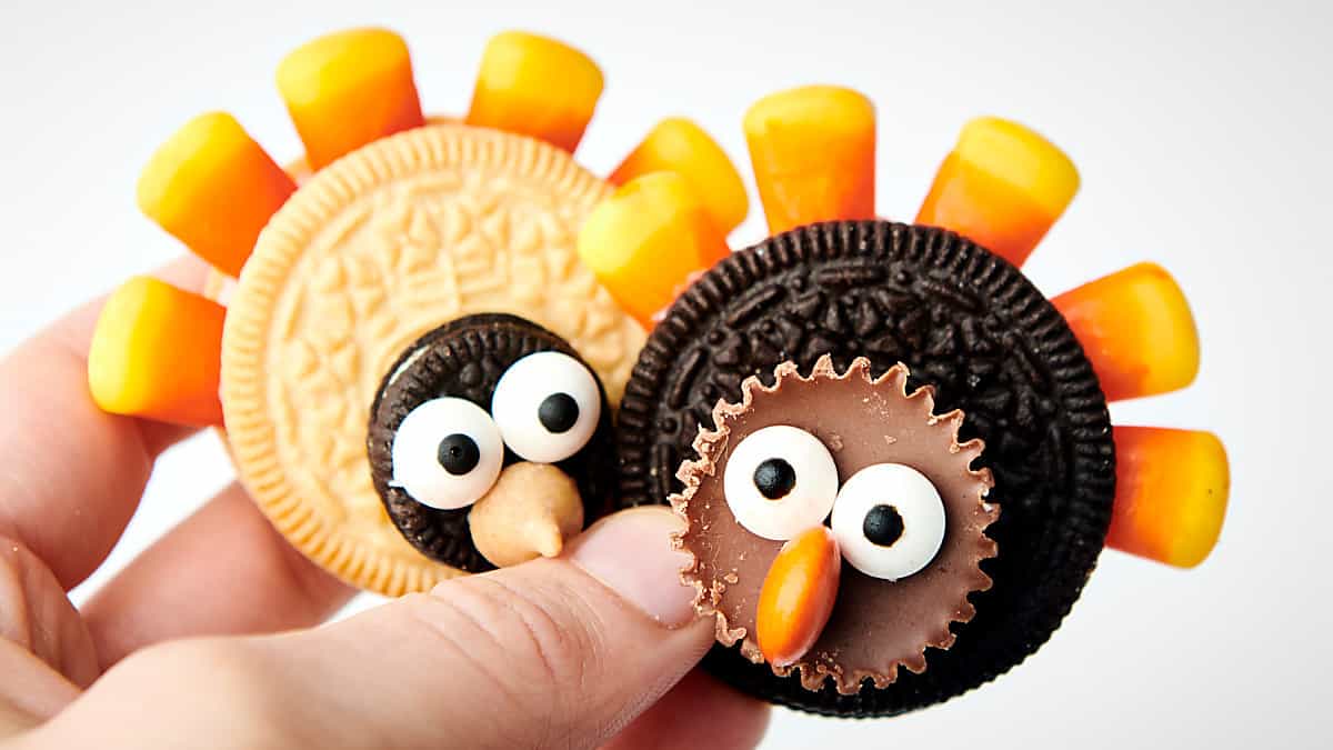 holding two turkey cookies