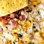 bowl of white chicken chili with bacon and cornbread