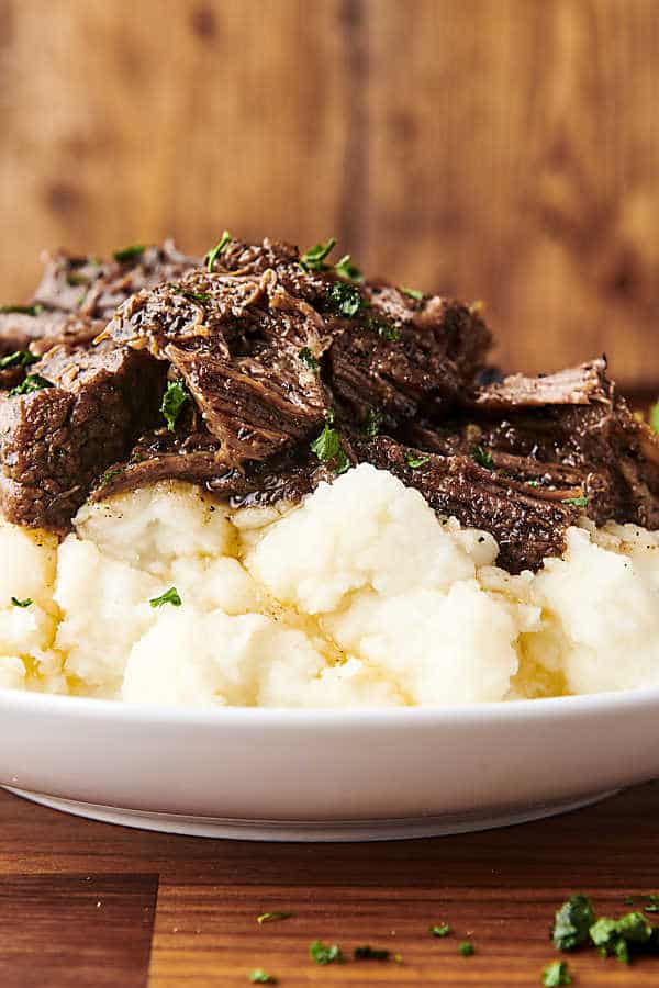braised beef spooned over mashed potatoes