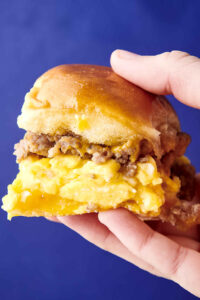 holding a sausage, egg, and cheese breakfast slider