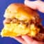 holding a sausage, egg, and cheese breakfast slider
