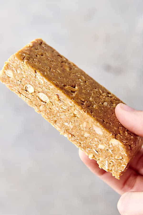 holding a peanut butter granola bar