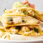 shrimp quesadillas stacked on a plate