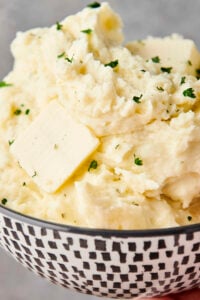 holding a bowl of mashed potatoes with boursin cheese