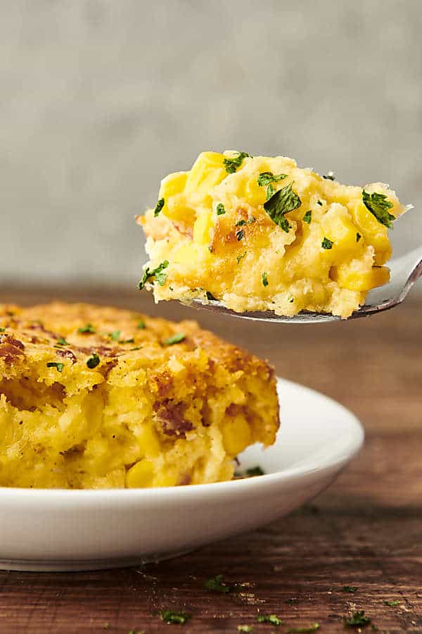 spoonful of corn pudding with bacon