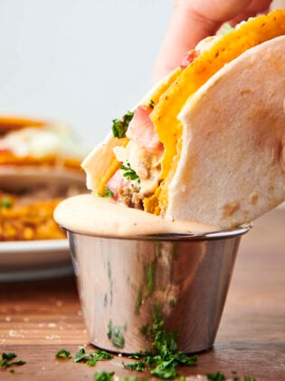 taco bell dupe: cheesy gordita crunch dunking in spicy ranch