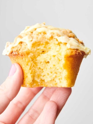 holding an orange crumb muffin
