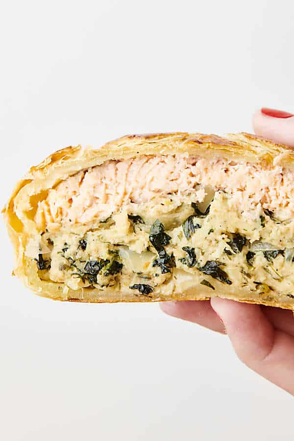 holding a slice of salmon on croute