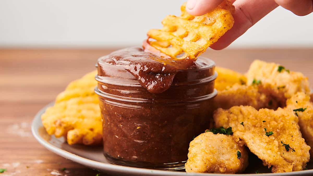 Dipping a waffle fry into homemade BBQ sauce