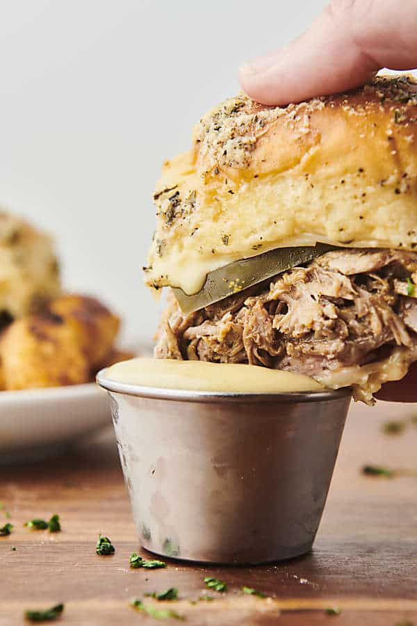 dunking a cuban slider into honey mustard