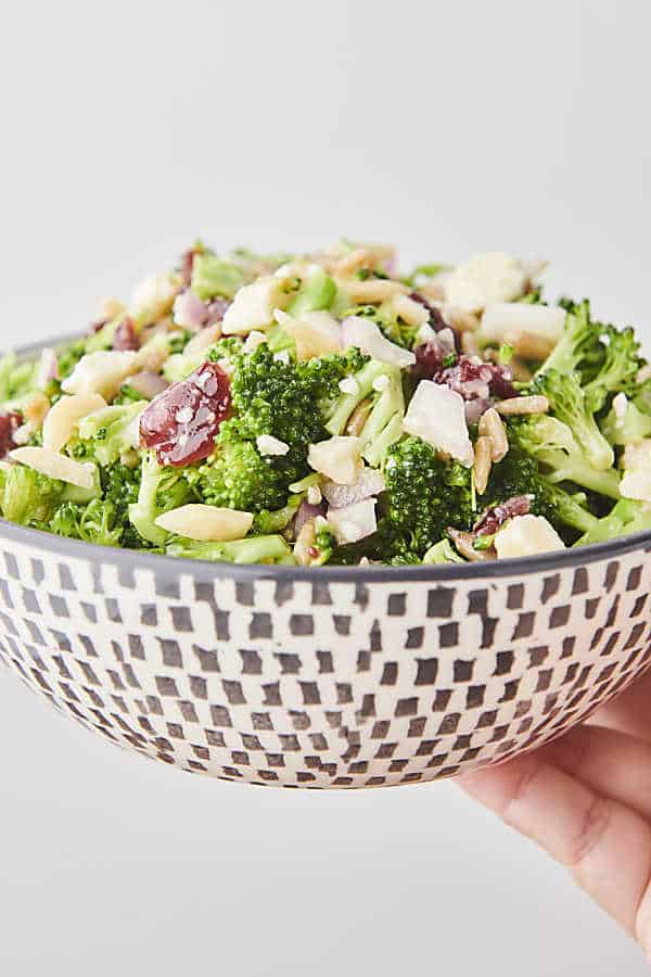 Holding a bowl of healthy broccoli salad