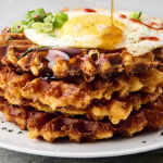 stacked mac and cheese waffles on a plate