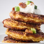 stack of loaded potatoes cakes made with leftover mashed potatoes