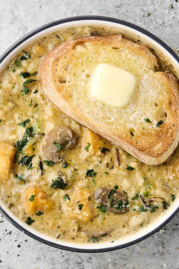 bowl of instant pot wild rice soup topped with toasted bread