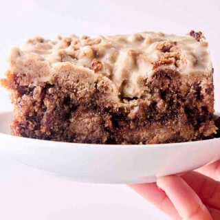 holding a plate of brown butter banana bread coffee cake