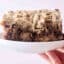 holding a plate of brown butter banana bread coffee cake