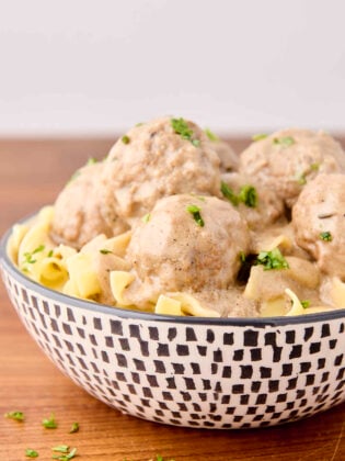 creamy swedish meatballs served with egg noodles in a bowl