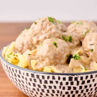 creamy swedish meatballs served with egg noodles in a bowl