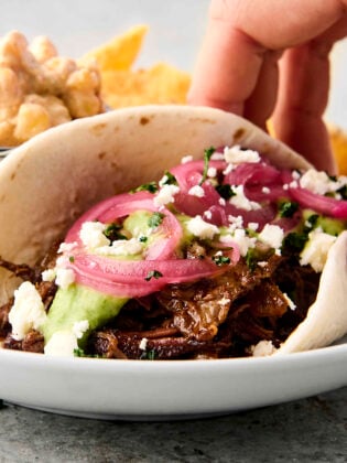 crockpot chuck roast taco with pickled onions and avocado sauce