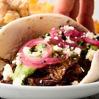 crockpot chuck roast taco with pickled onions and avocado sauce