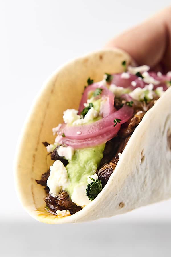 holding a chuck roast taco