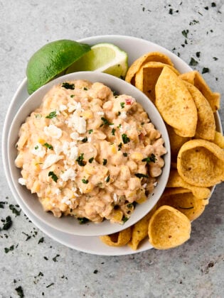 creamy Mexican street corn dip in a bowl with chips