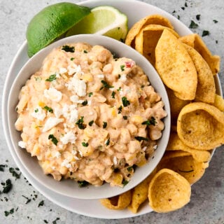 creamy Mexican street corn dip in a bowl with chips