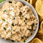 mexican street corn dip in a bowl with fritos