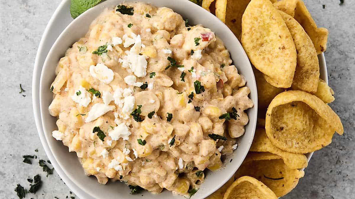 mexican street corn dip in a bowl with fritos