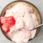 watermelon sherbet in a bowl with a spoon