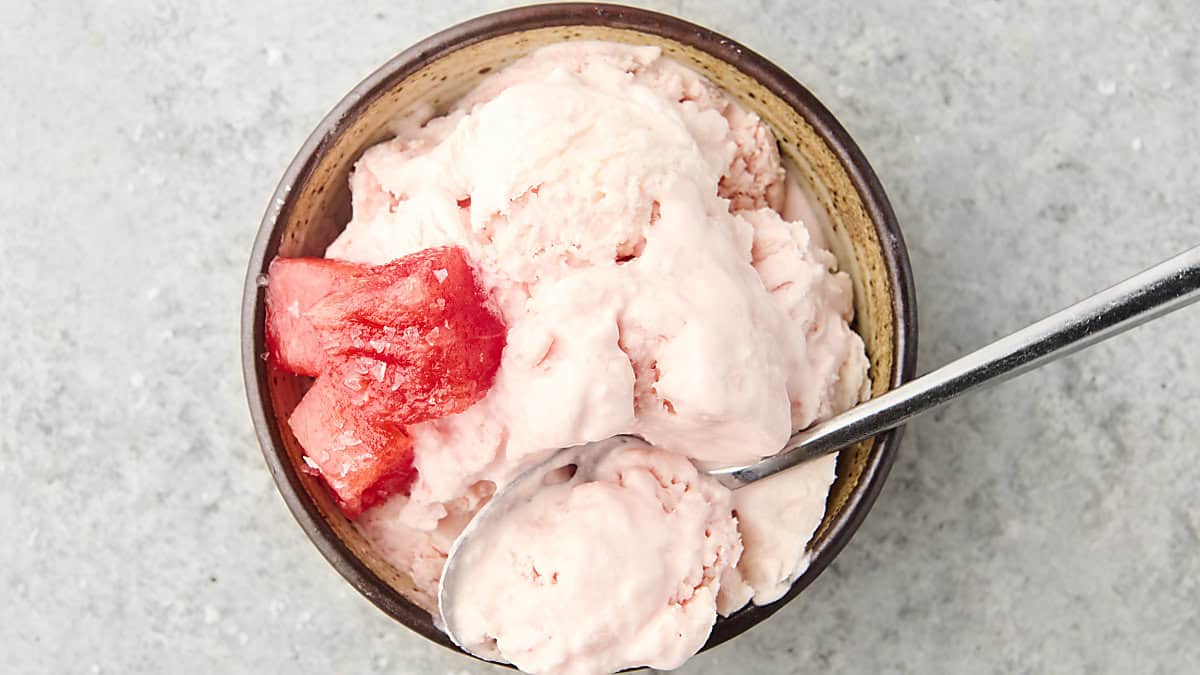 watermelon sherbet in a bowl with a spoon