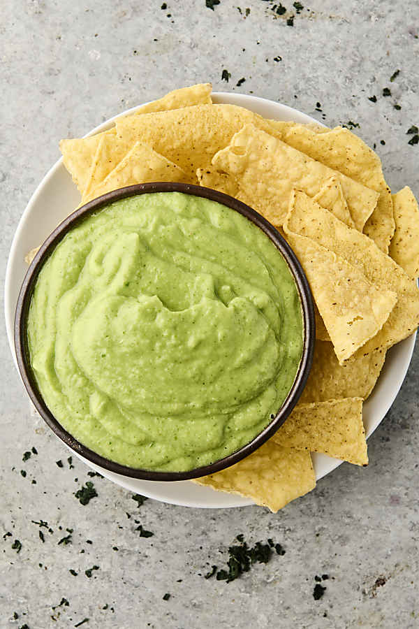 avocado sauce on a plate with chips