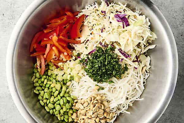 peanut noodle salad ingredients in a large bowl