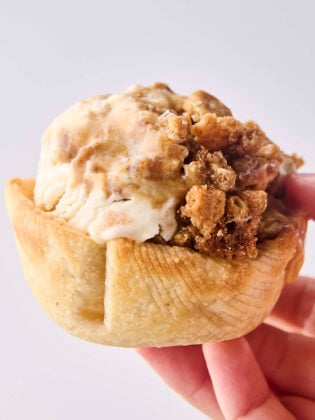 pie crust bowl filled with a scoop of caramel apple ice cream