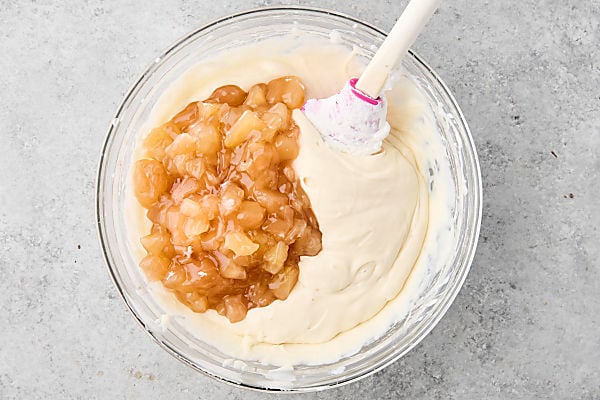 apple pie filling being stirred into ice cream base