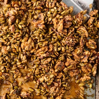 candied rosemary walnuts and pepitas on a baking sheet