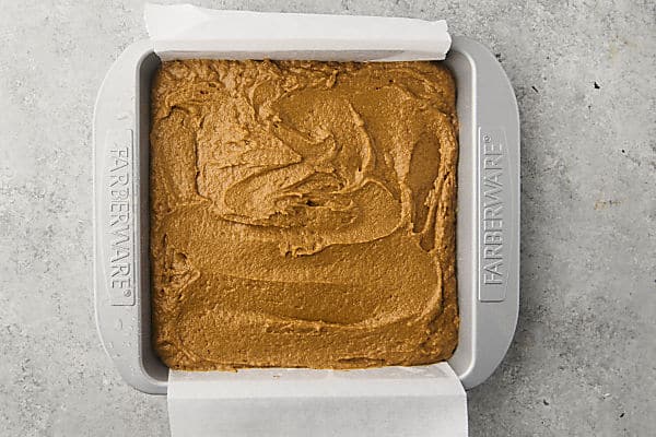 pumpkin crumb cake batter in a prepared 9x9 inch baking sheet